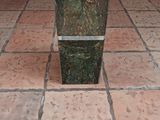 a green planter sitting on the floor in the middle of the room