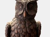 a statue of an owl that is sitting on a table