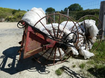 a wagon with bags of sand on the side of the road