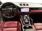 the interior of a car with red leather seats and a steering wheel