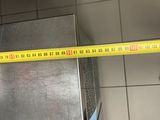 a measuring tape that is on the floor of a kitchen