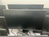 three computer monitors sitting on top of each other