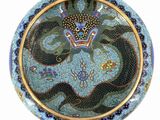 a picture of a blue and gold plate with a dragon on it