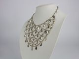 necklace made of silver metal beads on a white mannequin