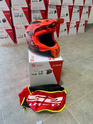 a helmet on the ground next to boxes of boxes