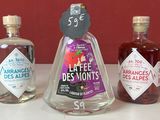 trois bouteilles d'alcool posées sur un plan de travail