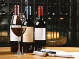 three bottles of wine and two glasses of wine on the table