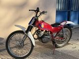 a red and white motorcycle parked in front of a building