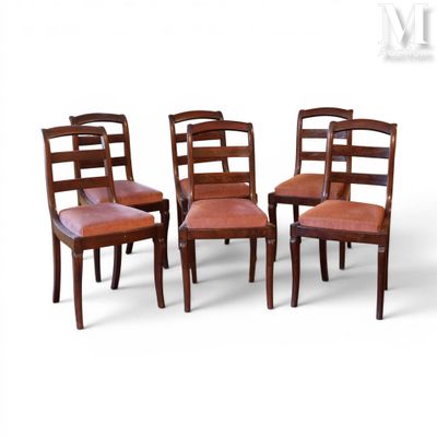 four wooden chairs with leather upholstered seats and a white background