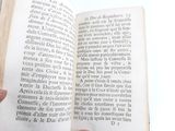 a person holding an open book in their hand