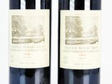 two bottles of wine sitting next to each other on a table