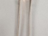 a close up of a pair of silver spoons on a white surface