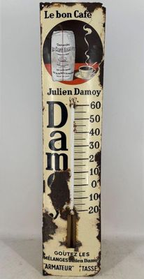 an old fashioned thermometer with a picture of a cat on it