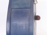 a blue dresser with a silver statue on top of it