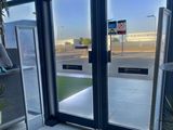 a picture of a large glass door with a sign on it