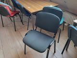 many chairs and tables in a room with a skylight