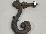 a metal hook that has a lion head on it