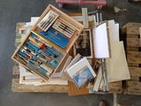 many different pens and pencils in a box on a pallet
