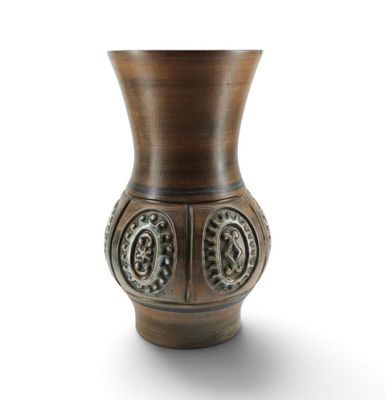 a brown vase that is sitting on a white surface