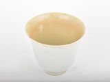 a white cup that is sitting on a table