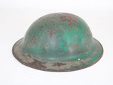 a green helmet on a white surface