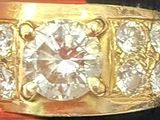 a gold ring with three diamonds on it