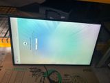 a computer monitor sitting on top of a cardboard box