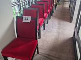 several red chairs are lined up in a row in a hallway