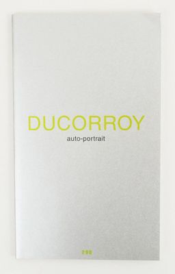 a white book with yellow lettering on it and a white background