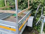 a trailer that has a cage on the back of it