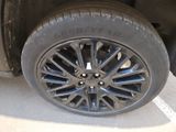 a close up of a tire on a car in a parking lot