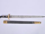 pair of two knives on a white surface one has a black handle and the other has a gold handle