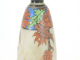 a vase with a design on it on a white surface