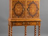 an old wooden cabinet with carvings on the doors and drawers