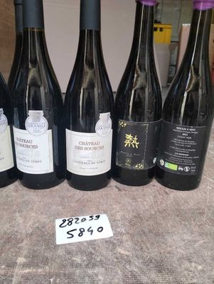 several bottles of wine are lined up on a table