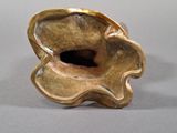 a gold vase that is sitting on a table