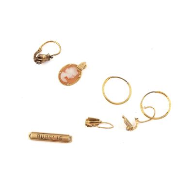 three gold rings and a ring with a pink stone on it