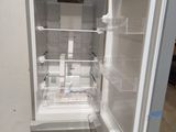 an open refrigerator in a room with a lot of shelves
