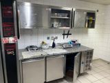 a kitchen with a sink, refrigerator, and dishwasher in it