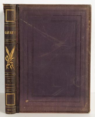 an old book sitting on top of a white table next to a book