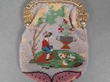 a beaded purse with a picture of a man and a dog on it