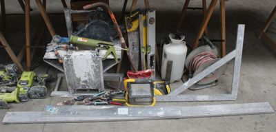 a pile of assorted items on the floor of a garage