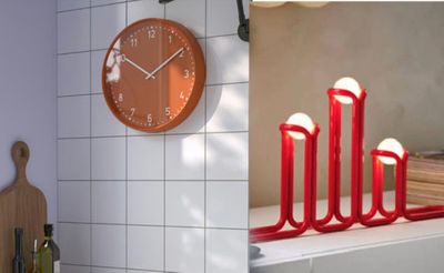 a clock that is on the wall next to some candles