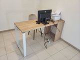 a desk with a computer on it and a printer on it