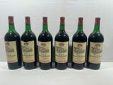 six bottles of wine are lined up on a table