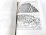 an open book with a drawing of a mountain and a river