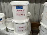 several buckets of paint are stacked on a pallet in a storage area