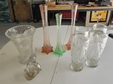three glass vases sitting on a table in a room