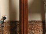 a wooden pedestal with a clock on top of it