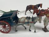 a group of toy figurines of horses pulling a carriage